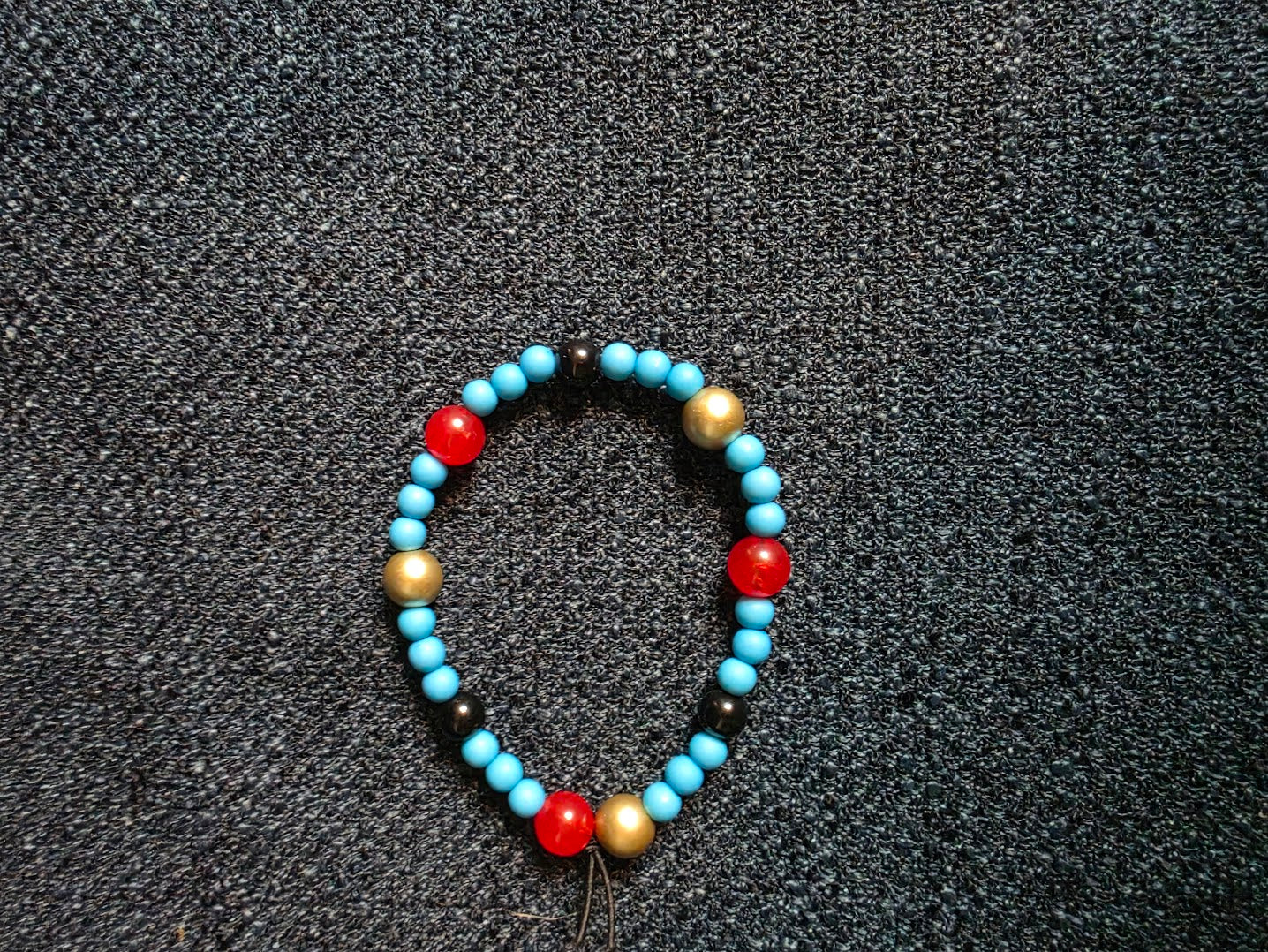 Red, Blue, Gold and Black Beaded Bracelet